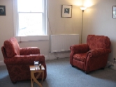 The therapy room: two armchairs beside a window
